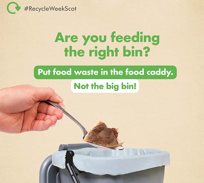 Photo of a hand putting a teabag into a food waste caddy