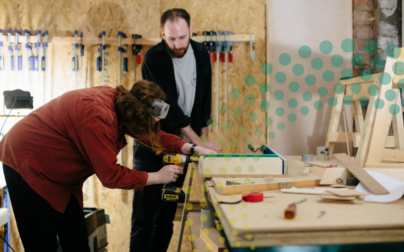 People working to repair an item in a reuse hub