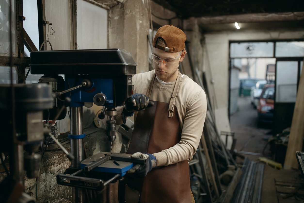 A person working on a remanufactured part with machinery