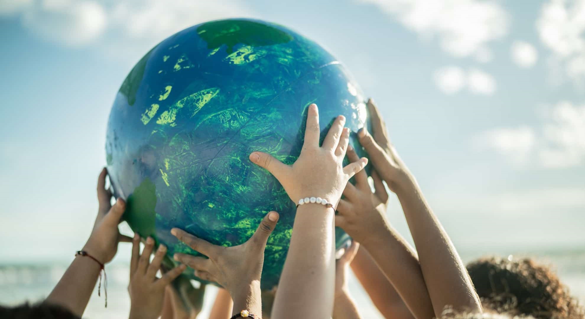 children holding up the earth with their hands