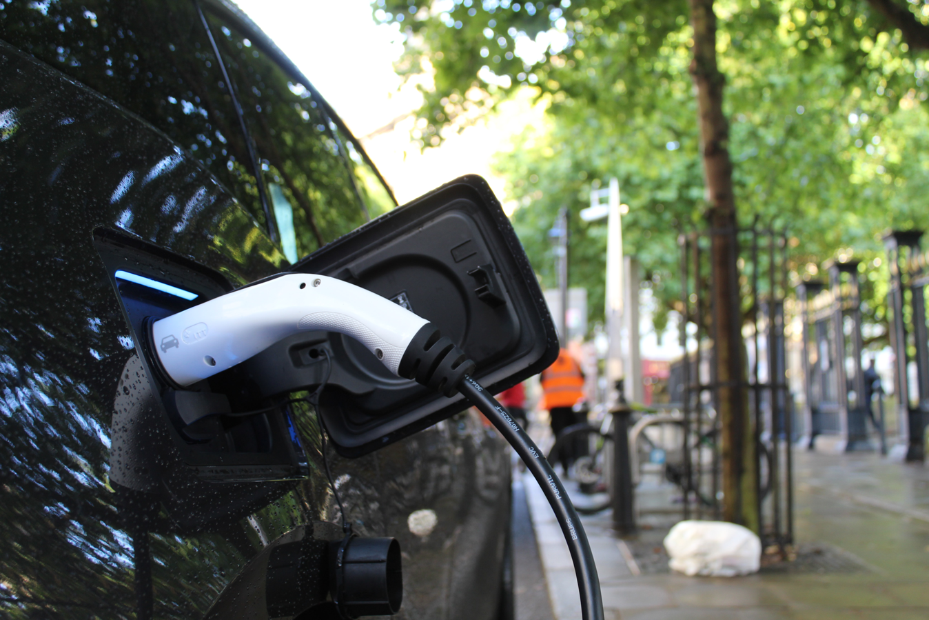 Electric car charging on a street